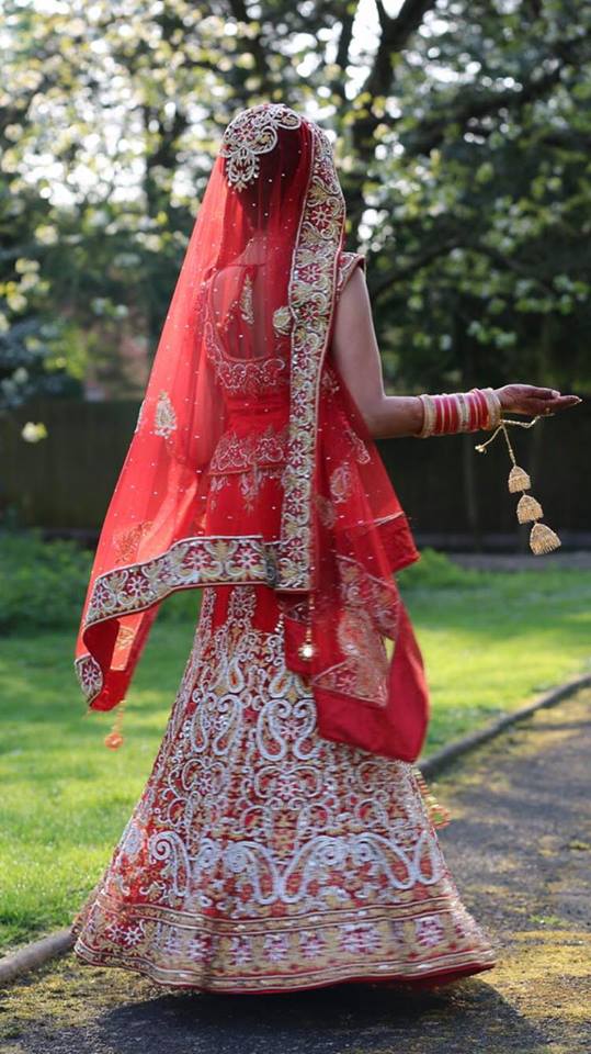 Bride from Canada wearing custom made red lehenga choli