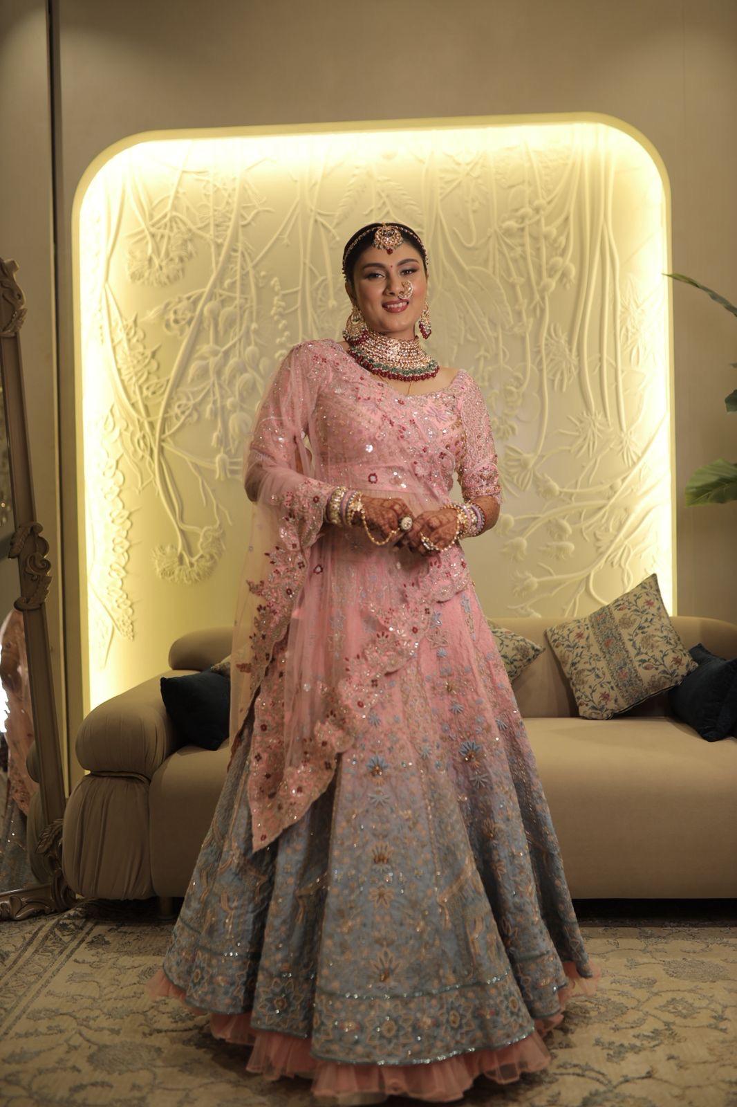 A bride from derby, UK posing in her custom made bridal lehenga